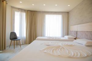 Postel nebo postele na pokoji v ubytování Hotel Dyrrah