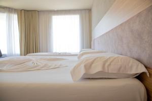 Postel nebo postele na pokoji v ubytování Hotel Dyrrah