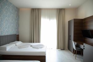 Postel nebo postele na pokoji v ubytování Hotel Dyrrah