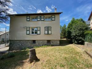 a house with a tree stump in front of it at Villa Meyronnes in Barcelonnette