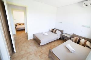 a hotel room with two beds and a couch at Elpida Village in Istro