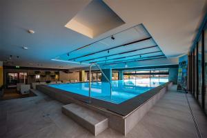 a large swimming pool in a building at Arena Franz Ferdinand Nassfeld in Tröpolach