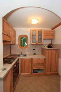 a kitchen with wooden cabinets and an arched ceiling at Holiday Home Vesna in Brod na Kupi +51 photos