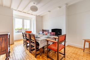 a dining room with a table and chairs at Seaview in Mundesley