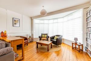 a living room with a couch and chairs and a table at Seaview in Mundesley