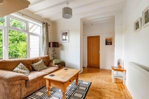 a living room with a couch and a table at Seaview in Mundesley