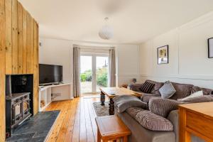 a living room with a couch and a fireplace at Seaview in Mundesley
