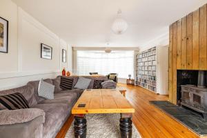 a living room with a couch and a table at Seaview in Mundesley +22 photos