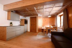a kitchen and dining room with a table and a couch at Ferienwohnungen Peisserhof in Sillian