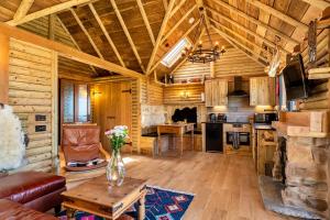 a kitchen and living room in a log cabin at Finest Retreats - Driftwood in Poundstock +36 photos