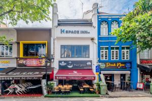 a group of buildings on a city street at K Space Inn 14 in Singapore