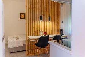 a room with a bed and a table and chairs at Apartments Villa Bazilika in Sečovlje