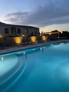 a large swimming pool in front of a house at Tenuta Paltusa in Calangianus