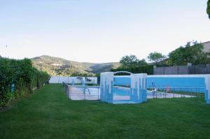 a yard with a swimming pool and a fence at La Alquería in Ráfales