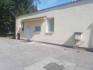 a white building with a door on the side of it at Apartman Tailor in Liptovský Mikuláš