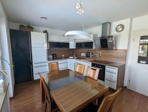 a kitchen with a wooden table and a dining room at Domen's cozy rentals in Kranj