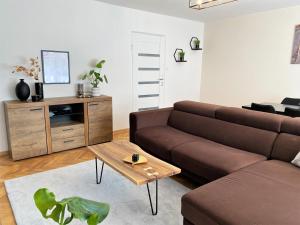 a living room with a couch and a coffee table at Apartament ul. Botaniczna in Mielec