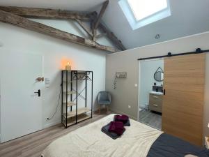 a bedroom with a large bed and a window at Les Iris - Chambre Chêne in Avanton