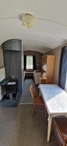 a living room with a table and a piano at Bungalåven Cottages & Rooms in Børselv