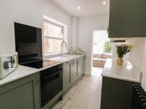 a kitchen with a sink and a counter top at Sole Bay Cottage in Lowestoft