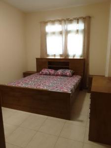 a bedroom with a bed and a window in a room at golden land in Sharjah