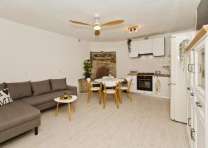 a living room with a couch and a table at Robinson house T'n'T in Hvar
