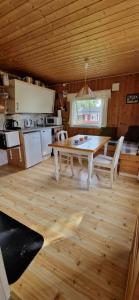 a kitchen and dining room with a table and chairs at Bungalåven Cottages & Rooms in Børselv