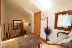 a living room with a couch and a stair case at Chalet junto a la Ciudadela de Jaca in Jaca