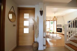 a hallway with a wooden door in a house at Chalet junto a la Ciudadela de Jaca in Jaca