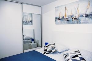 a bedroom with a bed and a painting on the wall at Brand new, luxury apartment SOL-Inn near Split with parking in Solin