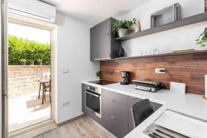 a kitchen with a white counter top and a table at Holiday house Mateo in Bubani