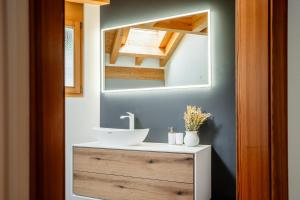 a bathroom with a sink and a mirror at Fantastic panoramic view home in Zermatt in Zermatt