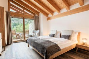 a bedroom with a large bed and a large window at Fantastic panoramic view home in Zermatt in Zermatt