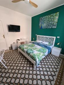 a bedroom with a bed and a green wall at Villa Corsini in Laigueglia +22 photos