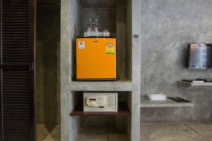 a yellow appliance sitting on a wall in a room at Buddy Boutique Inn in Bangkok