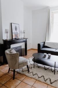 a living room with a couch and a table at Maison Madeleine in La Flèche