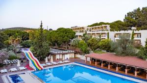 a resort with a pool and a water slide at PİGALE BEACH RESORT in Kuşadası