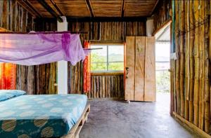 a bedroom with a bed and a window and a door at Casa Lily Flower in Playa Dormida