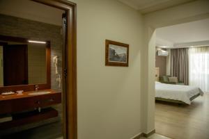 Postel nebo postele na pokoji v ubytování Hotel Dyrrah