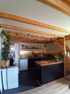 a kitchen with black counters and white appliances at Appartement 4 personnes in Briançon