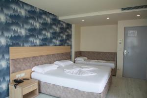 Postel nebo postele na pokoji v ubytování Hotel Dyrrah