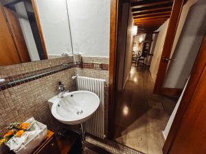 a bathroom with a sink and a mirror and a hallway at Relais nel Castello in Bassano del Grappa