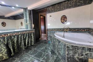a bathroom with a tub and a sink at NoVel 1 Luxury apt Katerini in Katerini