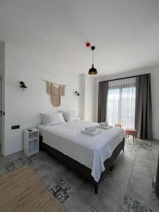 a bedroom with a large bed and a window at La Chance Otel Alaçatı in Alacati