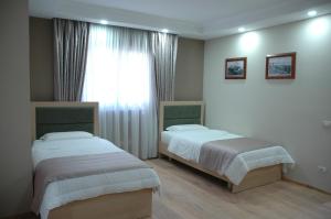 Postel nebo postele na pokoji v ubytování Hotel Dyrrah