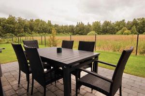 a wooden table and chairs on a patio at SeaFly in Palanga