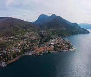 an aerial view of a town on the water with mountains at Emma House in Bellano