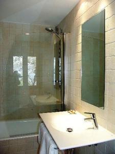 a bathroom with a sink and a shower and a mirror at badain in La Fortunada