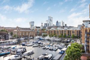 a marina in a city with boats in the water at The St Khatarine's Collection in London