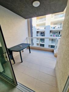 a balcony with a ping pong table in a building at Mela Apartment 1 in St. Paul's Bay +19 photos